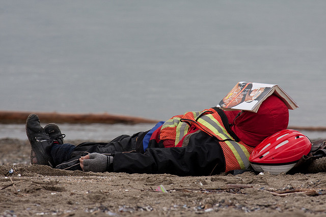 a person on a beach getting some serious rest 